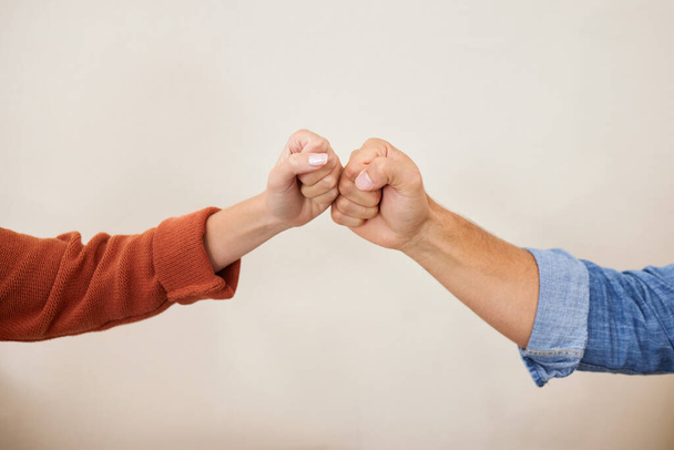 Fist bump, partnership and hands, people in a team with support, celebration and hello, success and solidarity. Synergy, cooperation and trust, agreement and deal with handshake and wall background. - Photo, Image