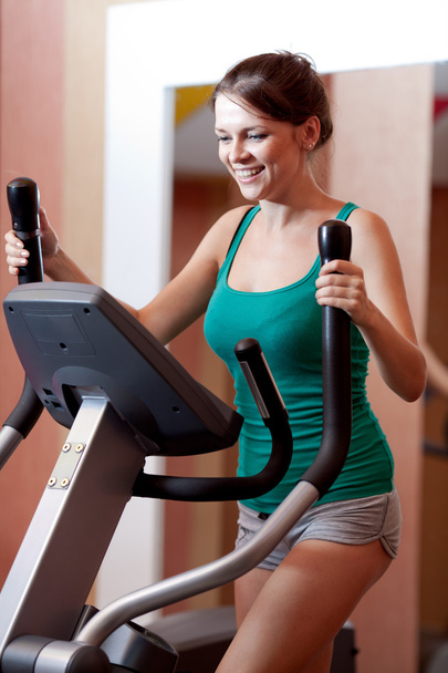 Young women in gym on stepper machine - Photo, Image