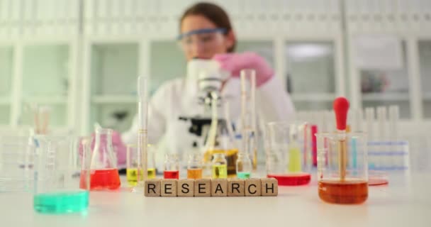Χημεία και δοκιμαστική γυάλινη φιάλη με πολύχρωμο διάλυμα σε ερευνητικό εργαστήριο. Μελέτη πολύχρωμων ουσιών στο εργαστήριο - Πλάνα, βίντεο