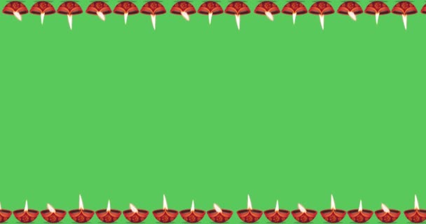 Animated motion graphics of Diwali Diya Oil Lamp moving up left and down right on a green background with space for text. Hindu festival background. - Footage, Video