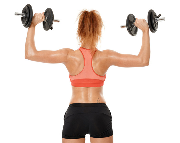 Young fit woman working out with dumbbells - Fotó, kép