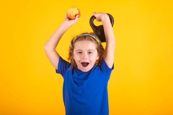 Kids sports exercises. Healthy kids life and sport concept. Portrait of child boy working out with dumbbells. Motivation and sport concept for children - Zdjęcie, obraz