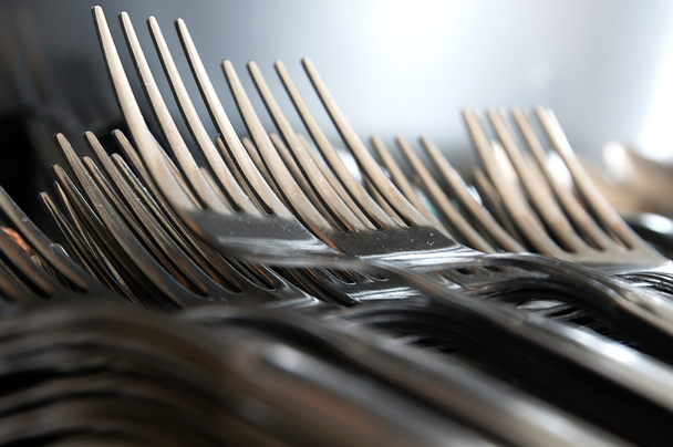 Forks arranged in series on the kitchen table. - Photo, image