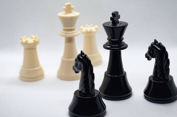 Chess game. Battle between black and white chess with white background. Strategy and battle concept. - Photo, Image
