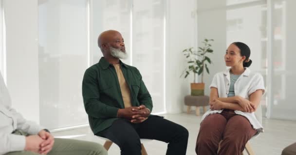 Black man, psychology or counselling meeting in circle for wellness with mental health, help or discussion. Empathy, senior or people speaking for trust, support or communication in group therapy. - Footage, Video