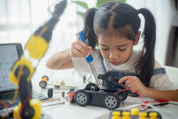 STEM education concept. Asian young girl learning robot design. - Photo, Image