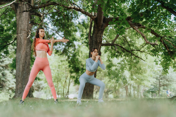 Активні жінки насолоджуються тренуванням на відкритому повітрі в міському парку - Фото, зображення
