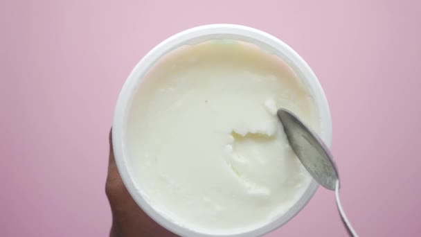top view of spoon pick fresh yogurt in a bowl on table , - Footage, Video