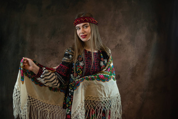 Ukrainian young pretty woman wear vyshyvanka national embroidered dress and handkerchief on head. Fashion concept, national  folk and culture - Photo, Image