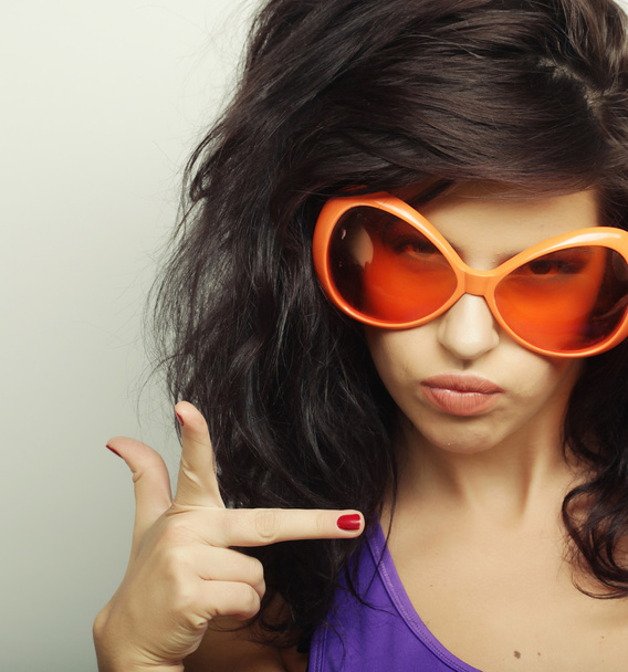 young woman with big orange sunglasses - 写真・画像