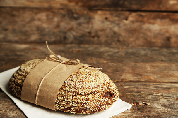 Fresh bread on old wooden table - Фото, изображение