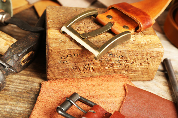 Craft tools with leather belt on table close up - 写真・画像
