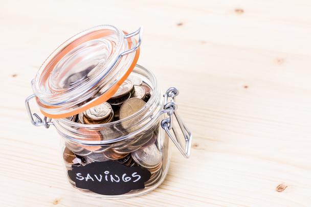 Saving money into glass jar - Fotoğraf, Görsel
