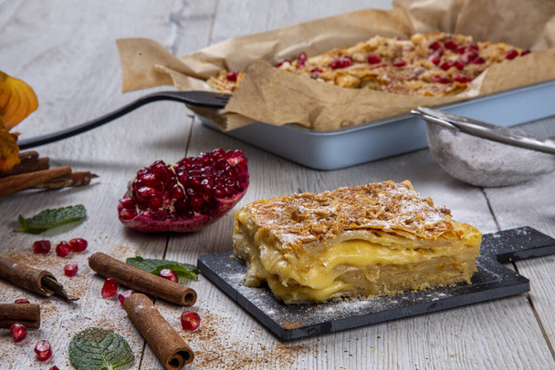 Kurdish pastry with cheese. A special and traditional pastry, sprinkled with powdered sugar and garnished with pomegranate and cinnamon. - Photo, Image