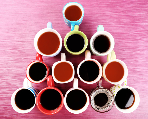 Many cups of coffee on pink background - Photo, Image