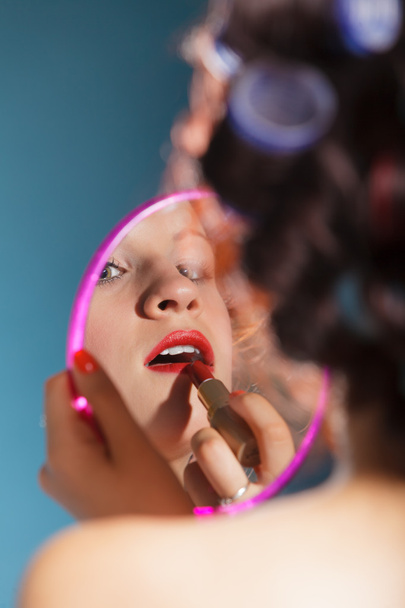 Girl applying red lipstick - Foto, immagini