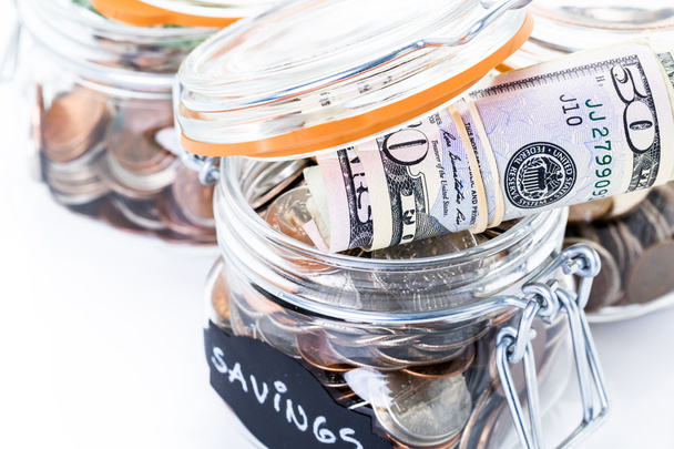 Saving money into glass jar - Photo, Image