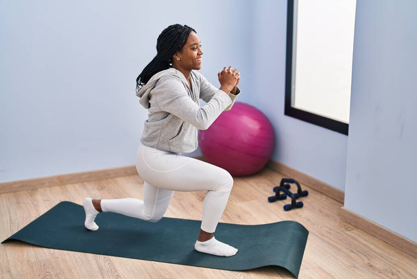 African american woman smiling confident training legs exercise at sport center - Valokuva, kuva