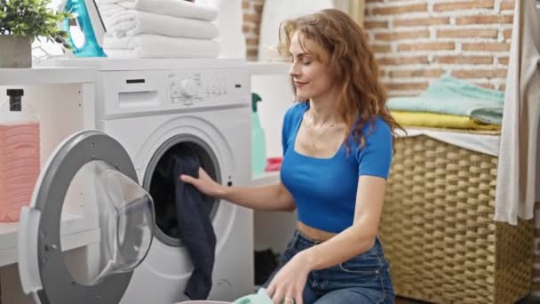 young happy woman doing laundry at home - Footage, Video