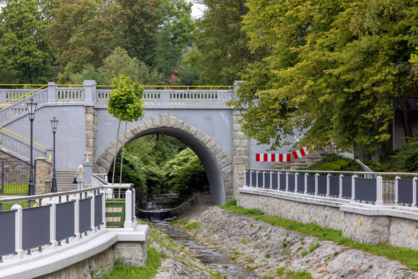 Krynica-Zdroj, Polsko - 31. srpna 2022: Kamenný most přes potok Kryniczanka u Mieczyslaw Dukiet Park - Fotografie, Obrázek