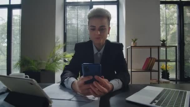 Young pleasant caucasian businesswoman chat with boyfriend using mobile phone. Student woman employee talking to friends via smartphone in office. Call center worker girl answering. High quality 4k - Footage, Video