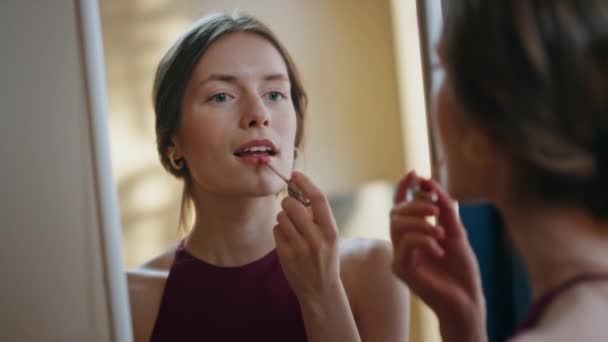 Woman applying shiny lipstick in mirror reflection closeup. Attractive girl do makeup getting ready for party romantic date. Confident elegant model using cosmetics at home. Daily beauty routine. - Footage, Video