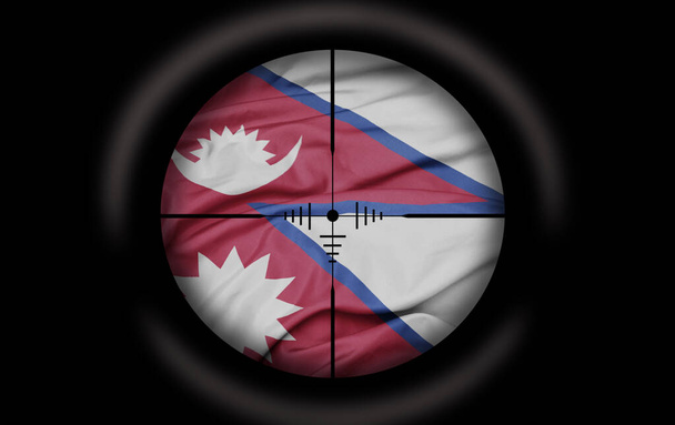 Снайперский прицел нацелен на большой красочный флаг непальской страны. концепция - Фото, изображение