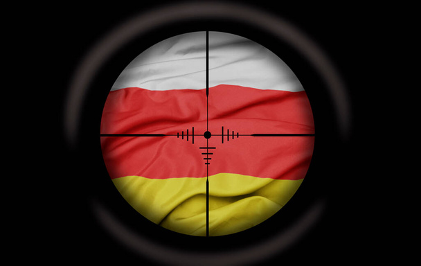 Scharfschützen zielten auf die große bunte Flagge des südostossetischen Landes. Konzept - Foto, Bild