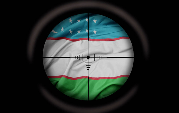 Mesterlövész távcső célozta meg a nagy színes zászló Üzbegisztán ország. fogalom - Fotó, kép