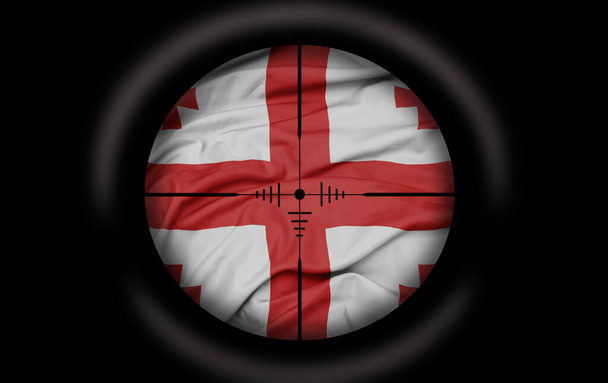 Sniper scope aimed at the big colorful flag of georgia country. concept - Photo, Image