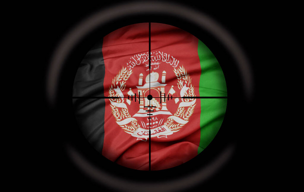 Снайперский прицел нацелен на большой красочный флаг Афганистана. концепция - Фото, изображение