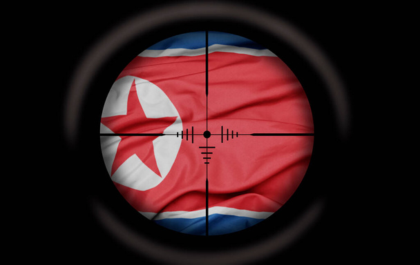 Scopo cecchino mirato alla grande bandiera colorata del paese della Corea del Nord. concetto - Foto, immagini