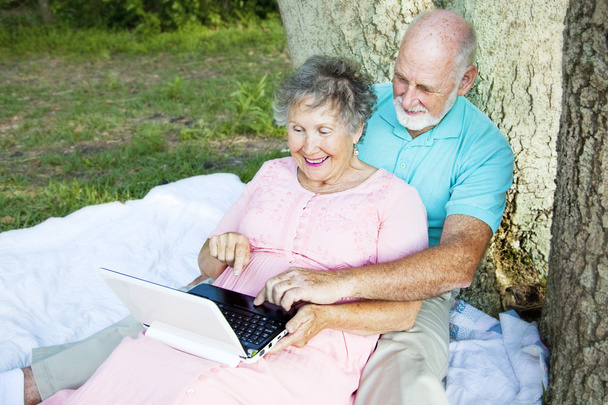 Senior Couple Computing Outdoors - Фото, зображення