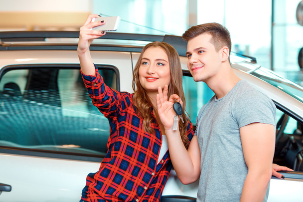 Happy young couple in dealership - Photo, Image