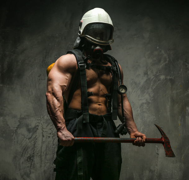 Muscular firefighter with axe - Photo, Image