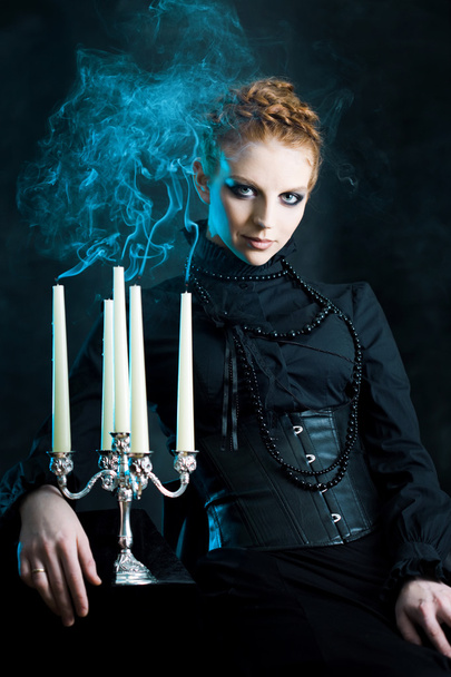 girl holds a candle stand extinguished candles, soft effect - Valokuva, kuva