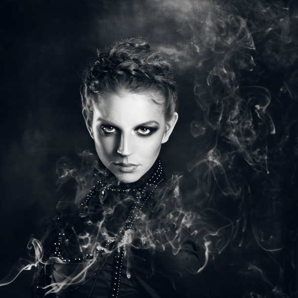 Mysterious portrait  beautiful females  in the smoke - Foto, afbeelding