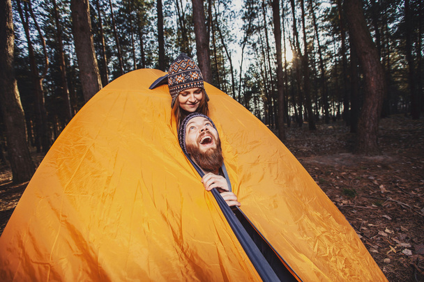 Hikers joking in the tent in the wood - Foto, afbeelding
