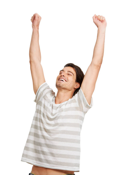 Man, arms up or celebrate in studio for happy smile, review results or cheers. Male model, hands or emoji excited face or achievement or yes, winner goal congratulations as mockup on white background. - Photo, Image