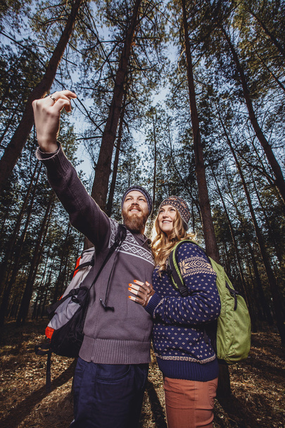 Couple of hikers in the wood - Photo, image