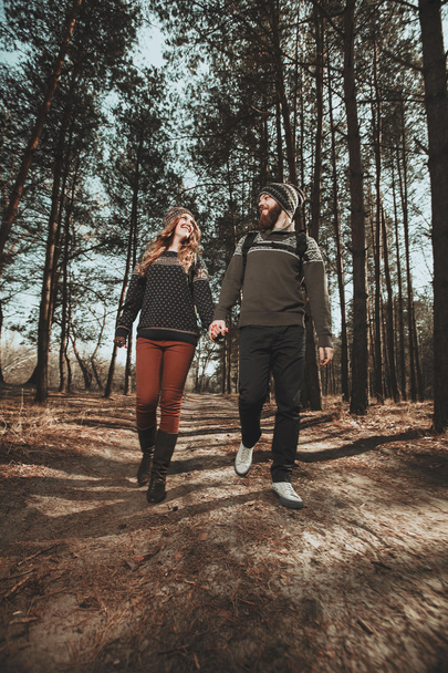 Couple of hikers walking in the wood - Photo, image