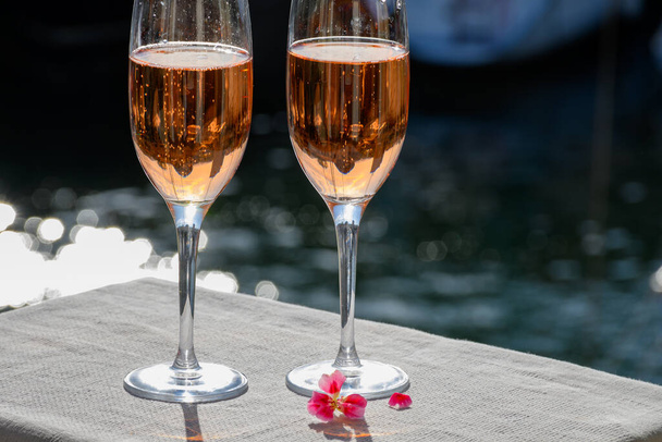 Summer party, drinking of French brut rose champagne sparkling wine in glasses in yacht harbour of Port Grimaud near Saint-Tropez, French Riviera vacation, Var, France - Photo, Image