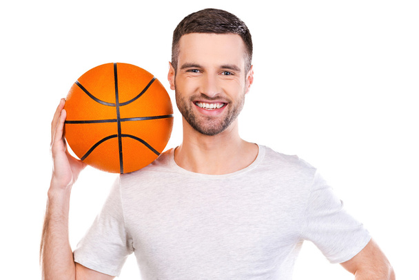 Young man carrying basketball ball - Zdjęcie, obraz
