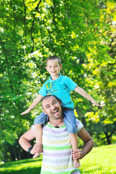 Happy father and son have fun at park - 写真・画像