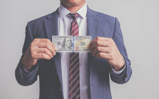 closeup businessman in suit holding one hundred 100 dollar bill. money concept - Foto, Bild
