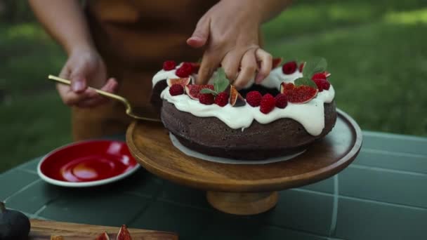 Egy darab finom házi torta friss bogyókkal a kerti asztalon a kertben. Kiváló minőségű FullHD felvételek - Felvétel, videó