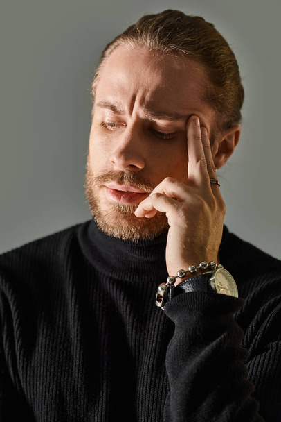 portrait of handsome man in black turtleneck sweater looking at camera on grey background - Fotoğraf, Görsel