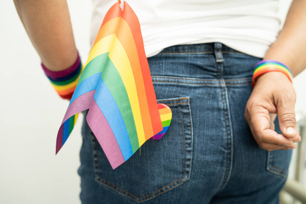 Žena držící LGBT duhovou vlajku, symbol lesbiček, gayů, bisexuálů, transsexuálů, lidských práv, tolerance a míru. - Fotografie, Obrázek