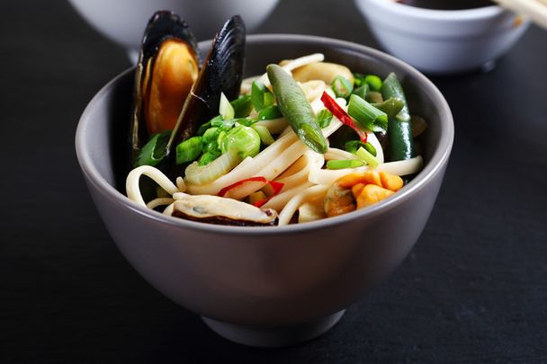 noodles with seafood in a bowl - Fotó, kép