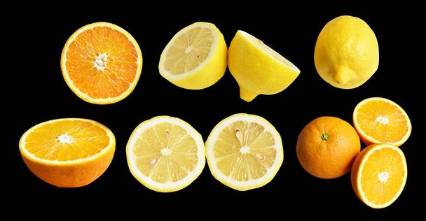 Gelbe Zitrone und orangefarbene Früchte isoliert mit Schneideweg vor schwarzem Hintergrund, kein Schatten, gesunde Fruchtscheiben - Foto, Bild